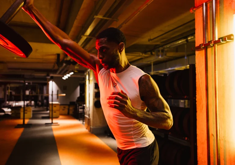 Member loading a barbell during a strength session